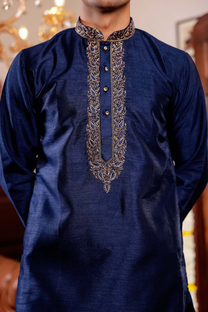 Navy Blue Raw Silk Kurta Suit with Intricate Embroidery on neckline.