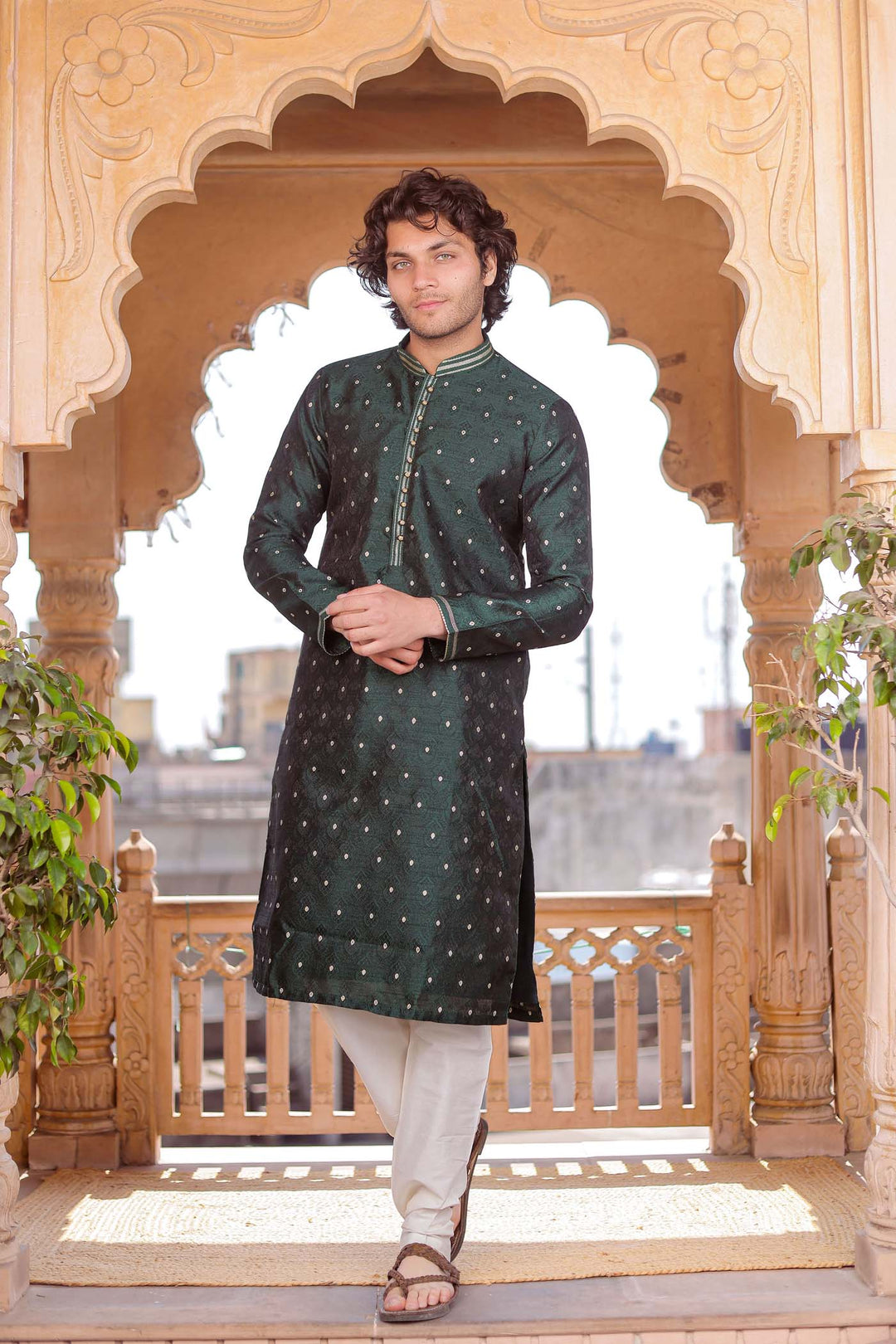 Bottle Green Brocade Silk Kurta Suit adorned with golden butti.