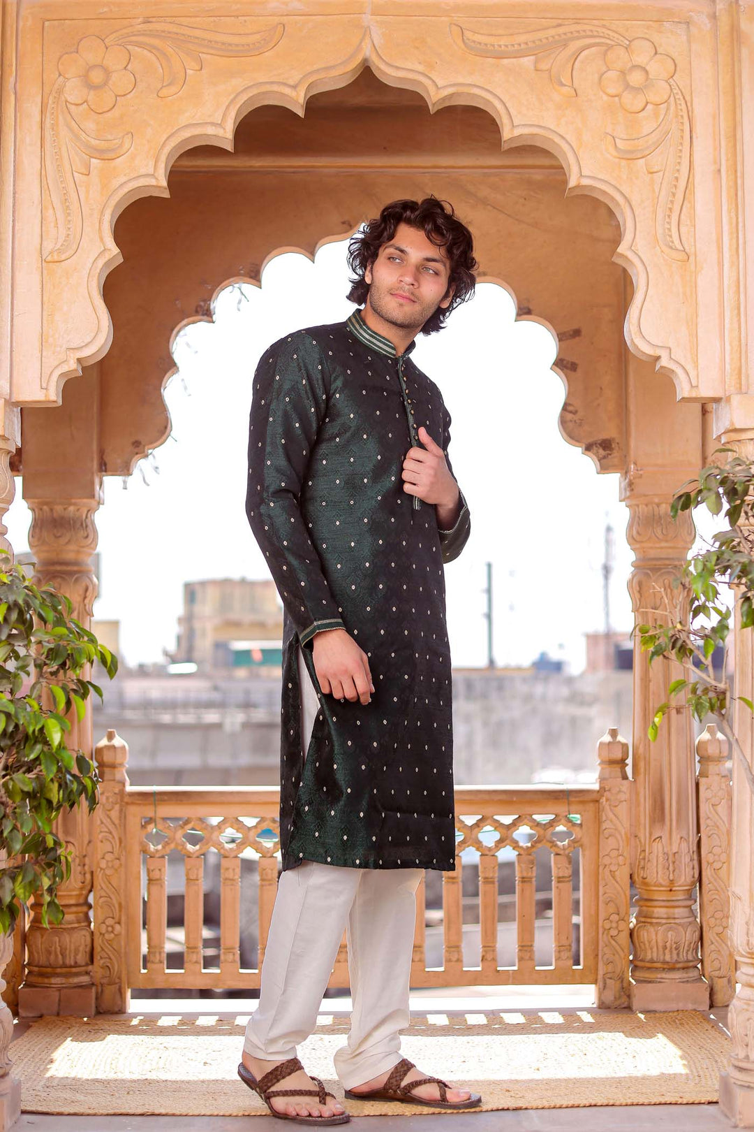 Bottle Green Brocade Silk Kurta Suit adorned with golden butti.