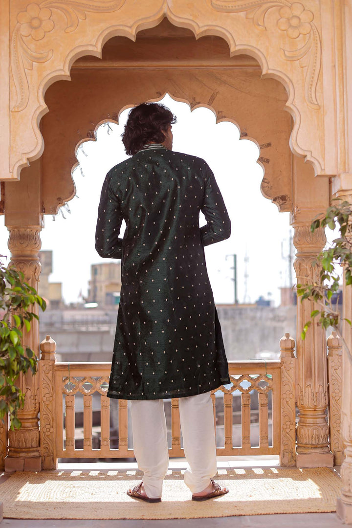 Bottle Green Brocade Silk Kurta Suit adorned with golden butti.