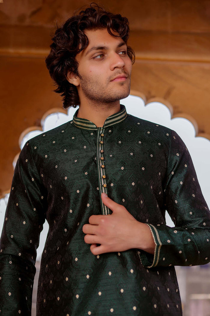 Bottle Green Brocade Silk Kurta Suit adorned with golden butti.