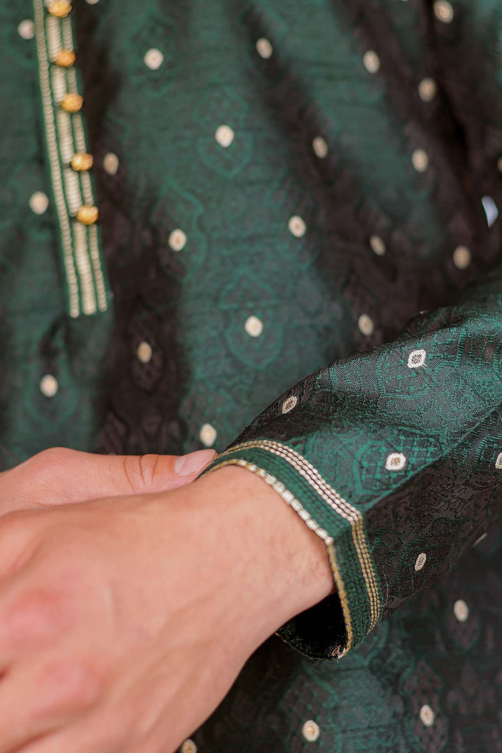 Bottle Green Brocade Silk Kurta Suit adorned with golden butti.