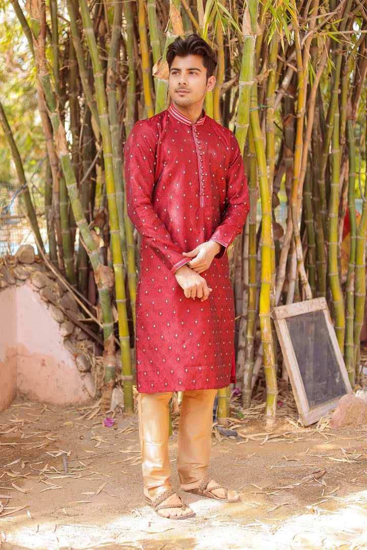 Maroon Brocade Silk Kurta Suit adorned with golden butti.