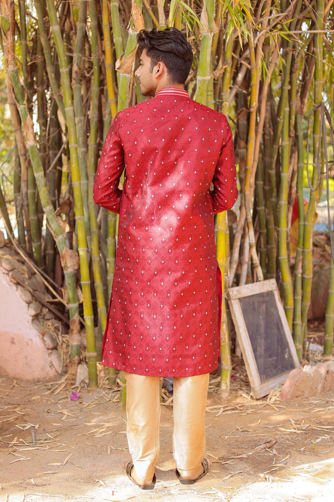 Maroon Brocade Silk Kurta Suit adorned with golden butti.